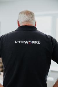 Back of a tutor wearing a Lifeworks polo shirt